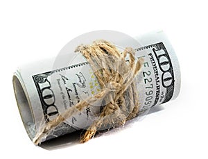 Dollars twisted into a roll isolated on white background.
