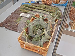 Dolls made of herbs in a woven birch bark box