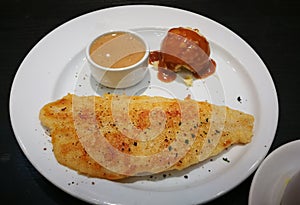 Dolly Fish Steak In white plate on black table