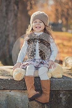 Dolly pin-up toothsome young brunette girl wearing fashion stylish gray jacket jerkin and warm hat with awesome boots clothes posi photo