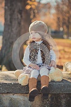 Dolly pin-up toothsome young brunette girl wearing fashion stylish gray jacket jerkin and warm hat with awesome boots clothes posi photo