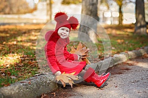 Dolly pin-up toothsome young girl wearing red blushful winter jacket and warm hat with boots fashion stylish clothes posing in aut