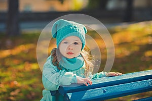 Dolly pin-up toothsome young girl wearing turquoise light blue jacket and warm hat fashion stylish clothes posing in autumn spring photo
