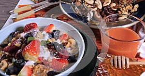 Dolly push out view of cereals with berries, dry fruits and milk