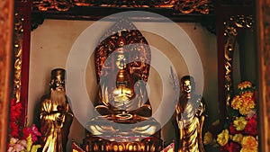 Dolly shot on golden Buddhist statues in Chinese temple