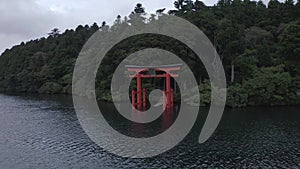 A dolly in shot of the Red Torii gate of Hakone shrine located on Lake Ashi