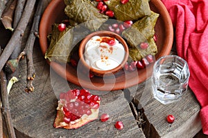 Dolma on a ceramic plate with pomegranate and chacha