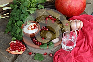 Dolma on a ceramic plate with pomegranate and chacha