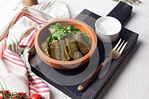 Dolma with parsley and sour cream still life in a crock