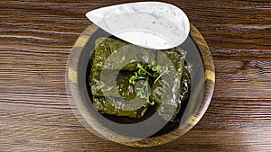 Dolma sarma or tolma stuffed grape leaves with rice, meat and white sauce cream