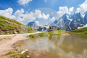 Dolomites Alps in Italy, Pale di San Martino mountains and Baita Segantini with the lake / landscape.