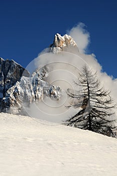 Dolomites Alps, South Tyrol, Italy. Cimon della Pala or Cimone with clouds in the Pale di San Martino Group