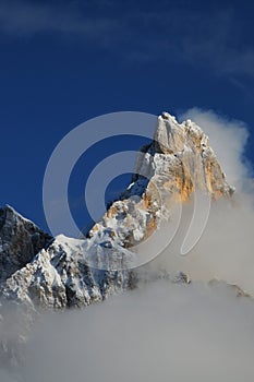 Dolomites Alps, South Tyrol, Italy. Cimon della Pala or Cimone with clouds in the Pale di San Martino Group