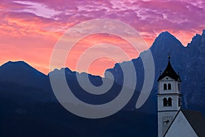 Dolomites Church Colle Santa Lucia at sunrise, Alps, Italy photo