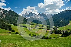 Dolomites, green mountains and grassland scenery under the blue sky and clouds