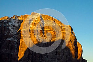 Dolomites rocky mountain wall in sunset light