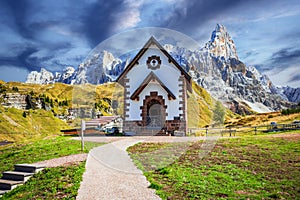 Dolomites, Sudtirol - Italy. Cimon della Pala mountain and the church of Passo Rolle