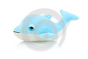 Dolphin plushie doll isolated on white background with shadow reflection. Plush stuffed puppet on white backdrop. Fluffy delphin