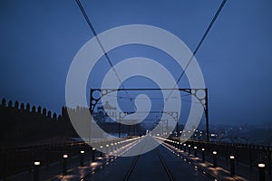 Dom Luis I Iron Bridge in cloudy weather at night, in Porto, Portugal.