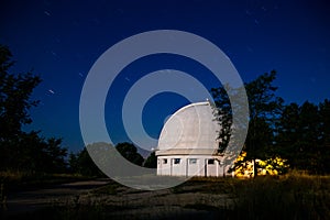 The dome of the astronomical telescope at night the stars Shine