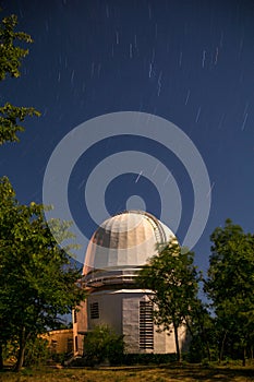 The dome of the astronomical telescope at night the stars Shine