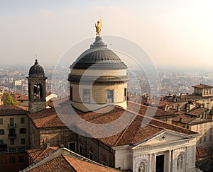 The dome of the cathedral in Bergamo showing the golden statue of Saint Alexander on