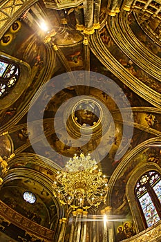 Dome in the church and handwritten icons in gold shades