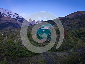 Dome in the forest and the Torres del Paine peak photo