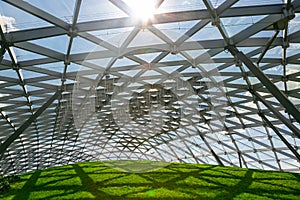 dome with glass roof under the open sky with sun glare.