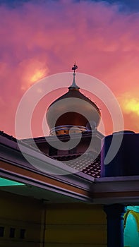 the dome of the mosque with a sunset background