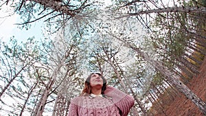 Dome from the pines trees at sky background overhangs over the young woman She enjoys the nature, by walking carefree