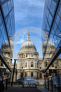 dome of Saint Paul\'s cathedral in London between mirror glass modern office buildings