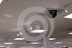 Dome security camera on top of ceiling inside Sears store