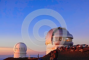 The dome-shaped observatory on top of the mountain at sunset.