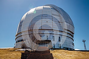 Dome of special astrophysical observatory on blue sky background at sunny day