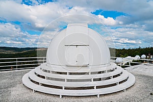 Dome of special astrophysical observatory on blue sky background at sunny day.