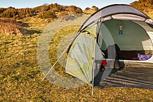 Dome tent pitched in wilderness photo
