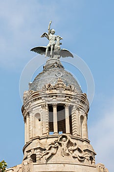 The Dome and top Statues of La Union and el Fenix on Passeig de Gracia, a Residential and office Building, Barcelona - Spain