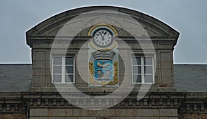 Domed building top with clock and coat of arms at Avranches, France photo