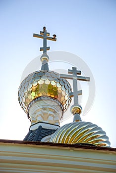 Domes of the Assumption Cathedral of the Dmitrov Kremlin on a blue sky.