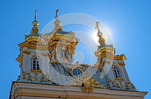 The domes of the church building. The domes are covered with gilding, they are crowned with crosses. Petergof, Russia