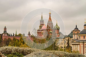 Domes of the famous St. Basil`s Cathedral on red square against a cloudy autumn sky, Moscow, Russia. The view from the Park