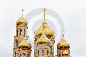 Domes of an Orthodox church against a cloudy sky