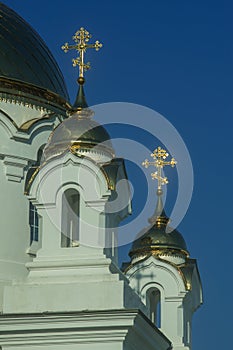 Domes of an Orthodox church with crosses against a blue sky