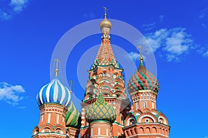 Domes of St. Basil`s Cathedral against blue sky
