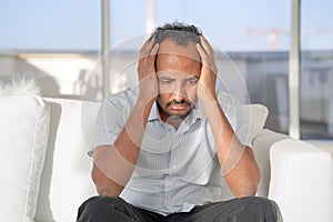 Domestic Abuse. Closeup of unhappy african man.The african male  put his hands to his head in trouble. People, domestic violence