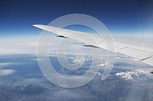 Domestic Airline Wing In Flight Over Mountains From Window