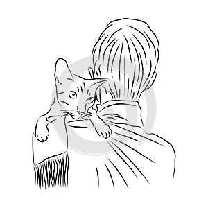 Domestic cat sits on shoulder of its owner. Showing love and caresses to pet. Animal care and protection concept