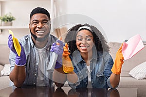 Domestic Chores Concept. Cheerful black couple posing while cleaning up house together photo