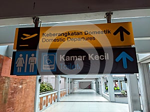 Domestic departure signs and restrooms at I Gusti Ngurah Rai Airport, Bali Indonesia